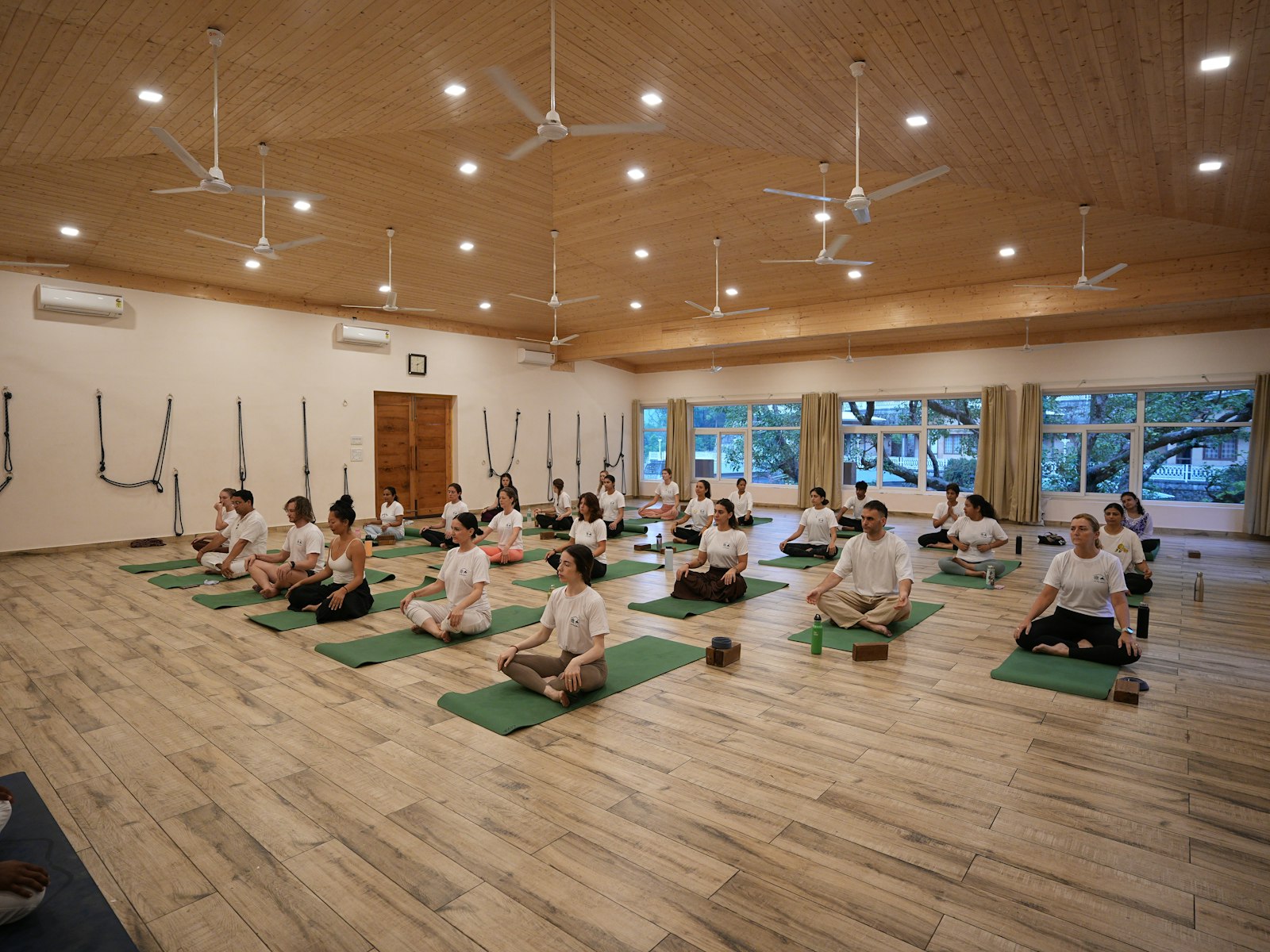 Team in a guided wellness session overlooking green grounds